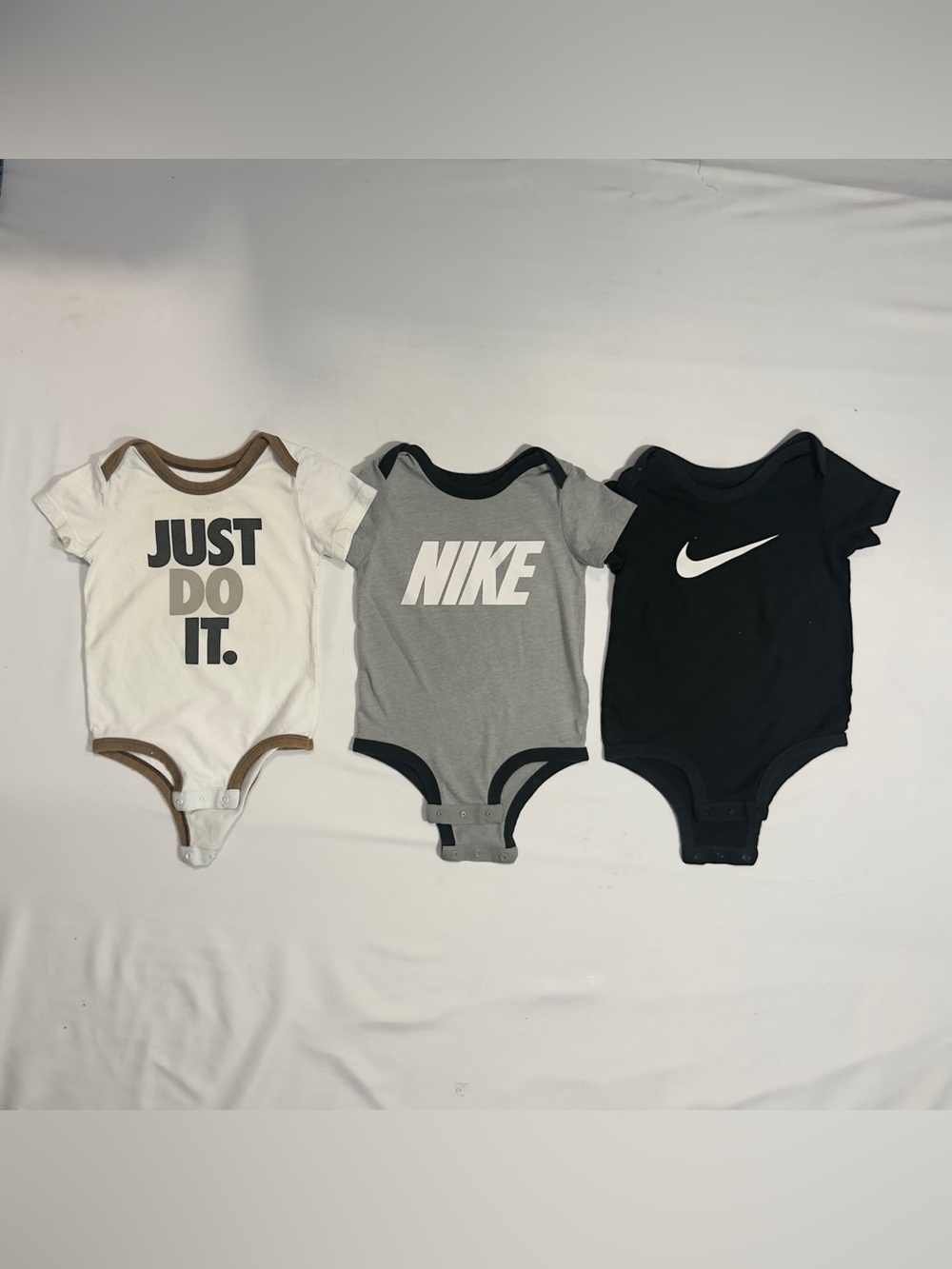 Nike Three-Pack Baby Bodysuits in White, Gray, Black